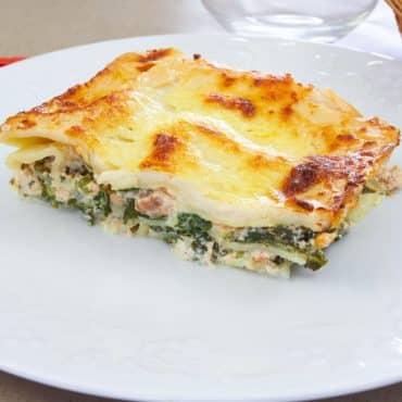 Salmon and spinach lasagna with a golden, creamy top