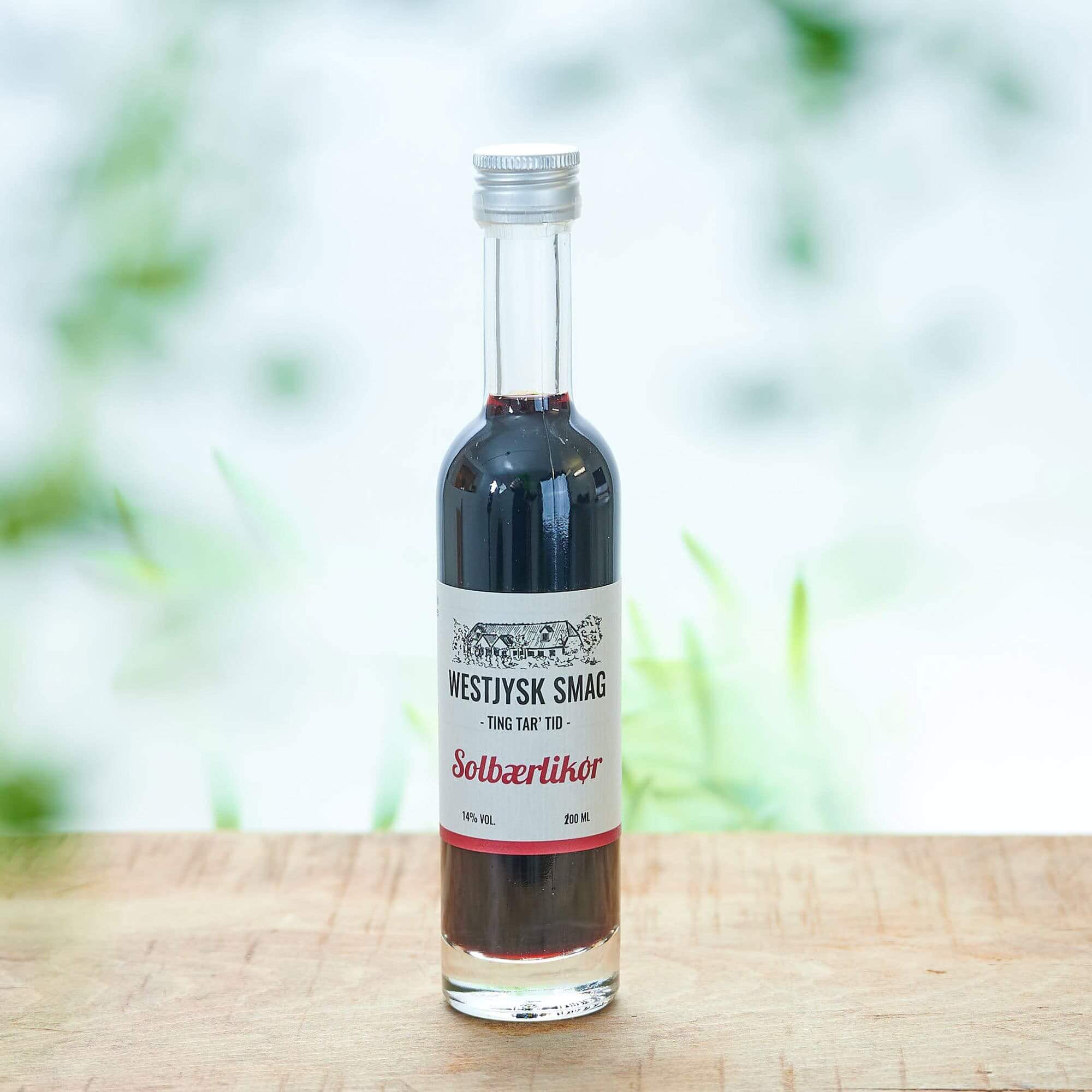 Flaske med Westjysk Smag Solbær likør klar til servering