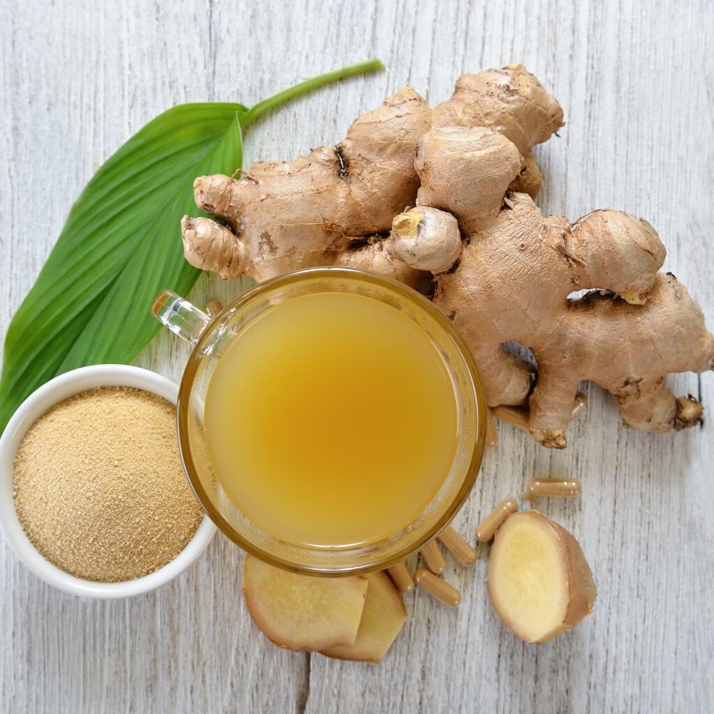 ingefær lagt på et bord frisk pulver og ingefær te