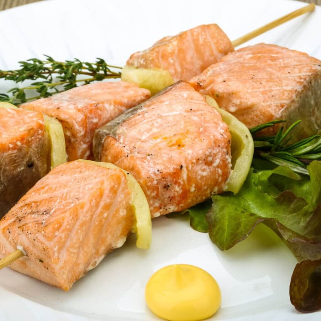 Juicy salmon skewers with caramelized glaze and salad