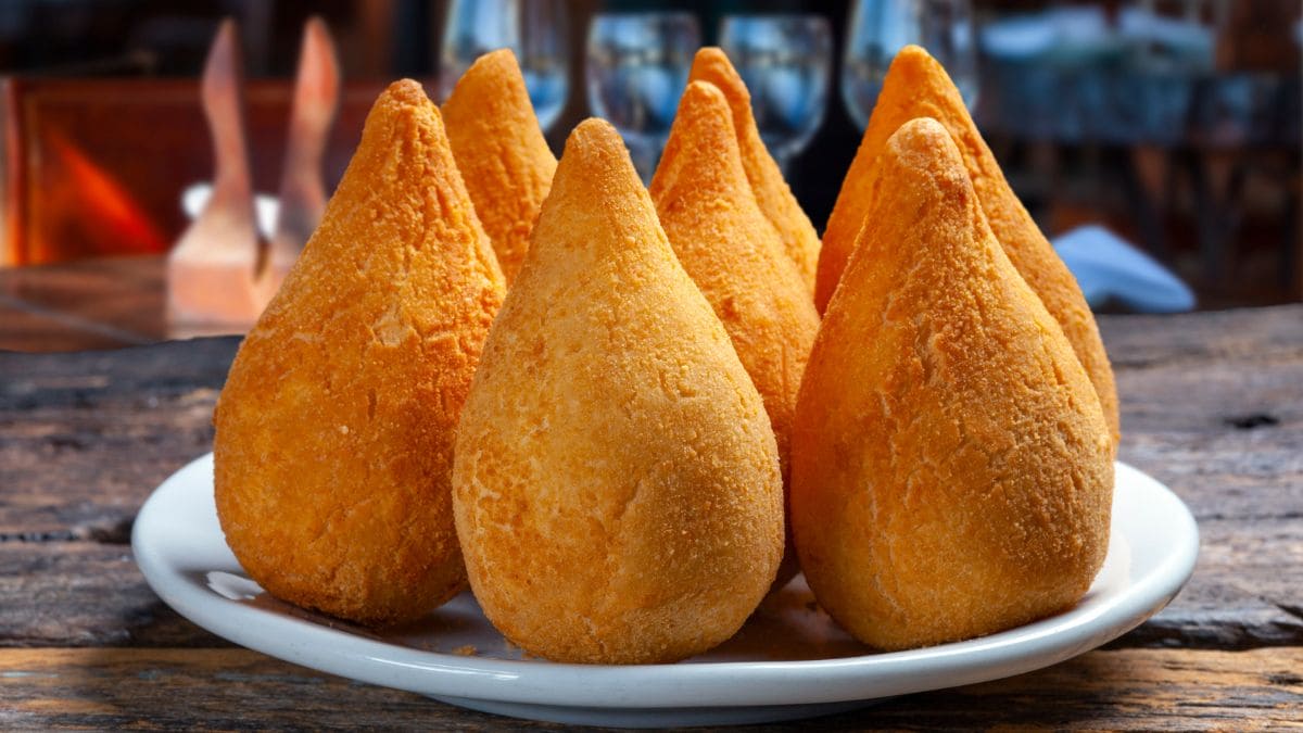 Coxinha er en brasiliansk streetfood, som består af strimlet kyllingekød, dækket af dej, støbt til en form, der ligner en tåre, og stegt